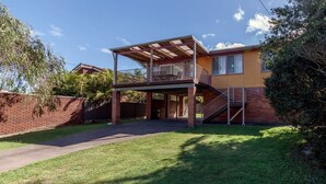 A two-story house with a covered patio and a staircase leading to a balcony. - Right across the road from Fingal Bay Surf Beach (Fingal Bay)