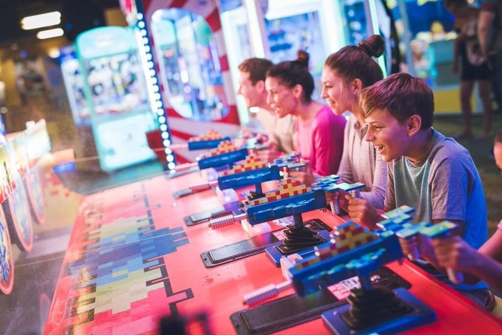 A row of arcade machines with colorful lights and joysticks.