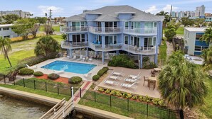 A multi-story building with balconies, a swimming pool, and outdoor seating areas. - Amadeus 7-Close to it all, Private Balcony, Pool! (Treasure Island)
