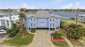 A two-story building with a flat roof, a balcony on the second floor, and a sign that reads 'AMADEU.' - Amadeus 7-Close to it all, Private Balcony, Pool! (Treasure Island)