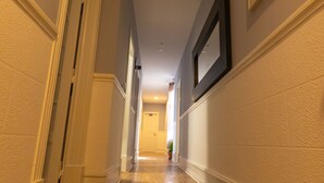 A hallway with wooden flooring, white walls, and a door at the end. - The Delight Hostel Lisbon (Lisbon)