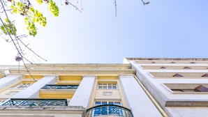 A building with a green gate, a sign indicating 'Desire Hotel', and a number '95' on the facade. - The Delight Hostel Lisbon (Lisbon)