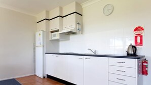 Fridge, microwave, stovetop, dining tables