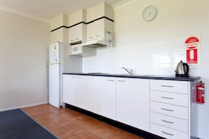 Fridge, microwave, stovetop, dining tables