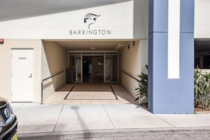 A building entrance with a sign reading 'BARRINGTON' and a fire safety door on the left.