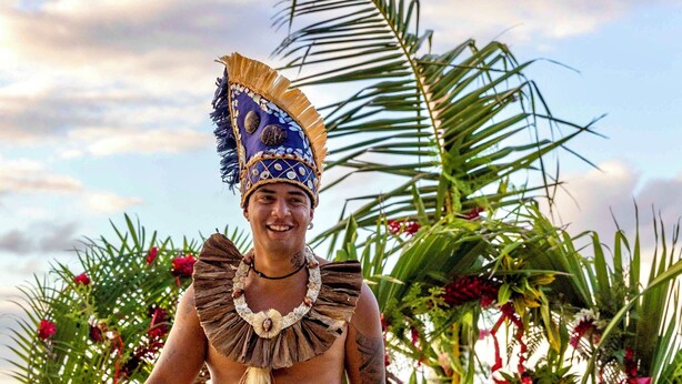 A person walking on a beach with palm trees and flowers. - EDEN - Private Island - TAHA'A (Taha'a)