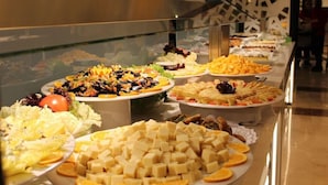 A buffet with various food items including salads, cheeses, and fruits. - Evenia Olympic Resort - Olympic Park (Lloret de Mar)
