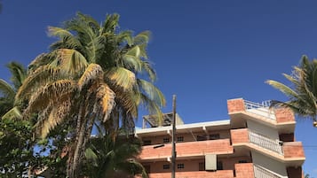 A multi-story building with balconies and a staircase.