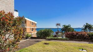 A multi-story building with a view of the sea. - A ground floor unit, close to town (Nelson Bay)