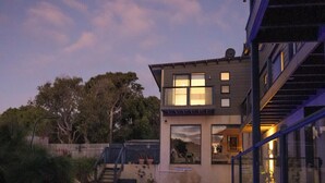 A modern house with a swimming pool at dusk. - “ROCKPOOL” Holiday Beach House Margaret River (5 bedrooms,  walk to beach) (Gnarabup)