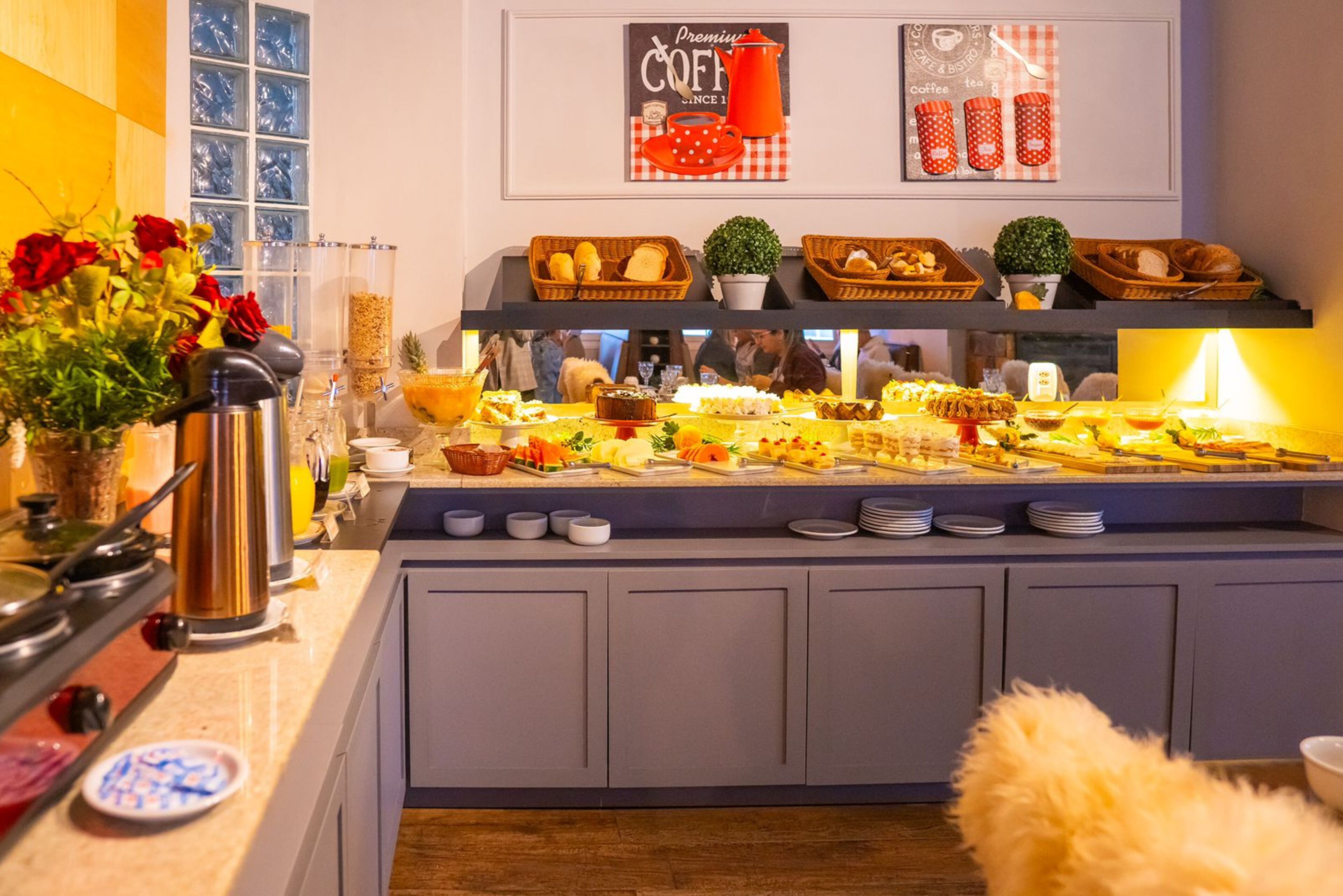 A buffet setup with various food items and a coffee station.