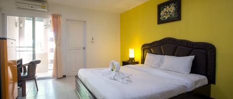 Una habitación de hotel con una cama, un escritorio y una silla.