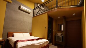 A hotel room with a wooden bed, a balcony with a wrought iron railing, a bathroom with a sink and mirror, and an air conditioning unit on the wall. - Sanyi Sakura Resort (Sanyi)