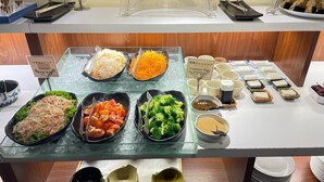 A buffet with various dishes including salads, vegetables, and Japanese-style dressing. - Azumaya Hotel Phnom Penh (Phnom Penh)