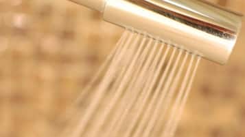 A showerhead with water flowing from it.