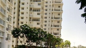 A multi-story residential building with a landscaped area in front. - TripThrill Maytas Hill Apartments (Hyderabad)