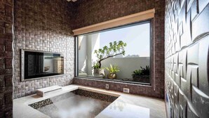 A modern bathroom with a large window, a built-in bench, and a small plant arrangement. - Aurora Motel (Taichung)