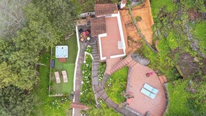 An aerial view of a property with a hot tub, outdoor seating, and a garden area. - GC0004 Cosy cave cottage & private jacuzzi in Fontanales (Moya)