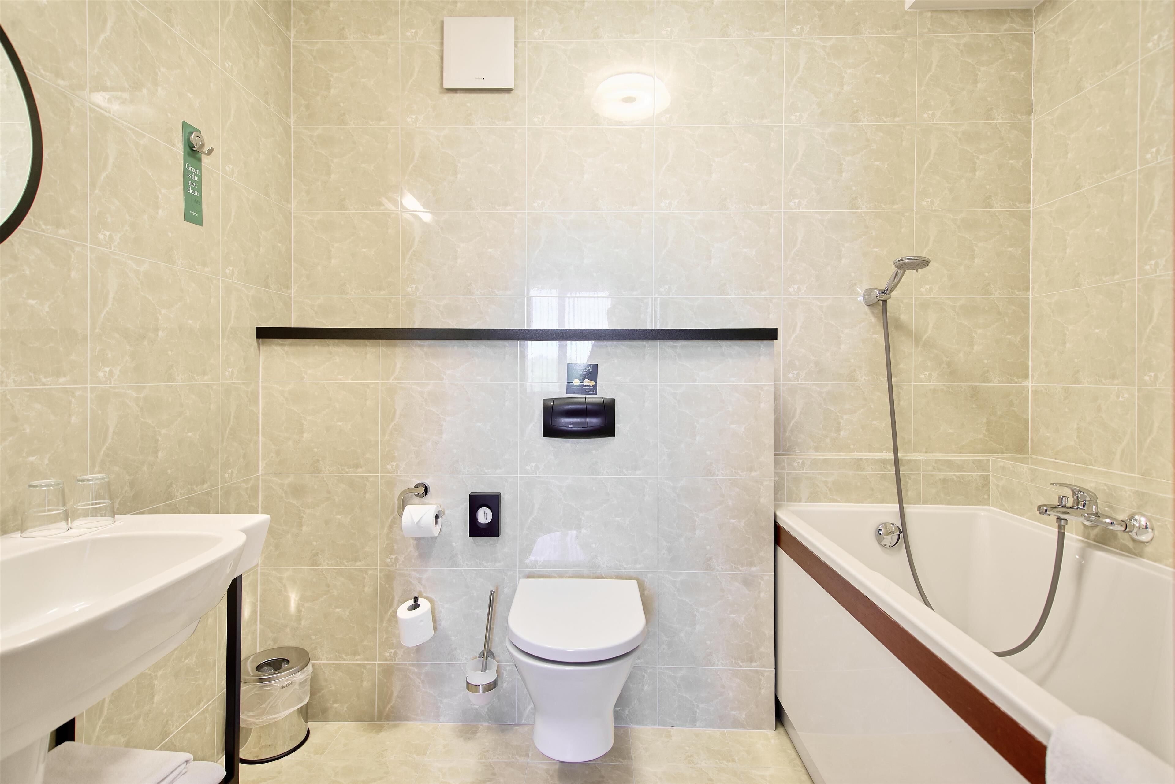 A bathroom with a sink, toilet, and bathtub.