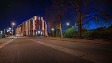 Stunning building with a prominent entrance, surrounded by well-maintained sidewalks and lush trees.