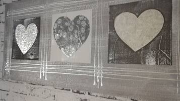 A wall with three heart-shaped decorations in a rectangular frame.