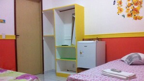 A room with a bed, a wardrobe, a small refrigerator, and a shelf unit. - Pousada São Bento II (Sao Bento do Norte)