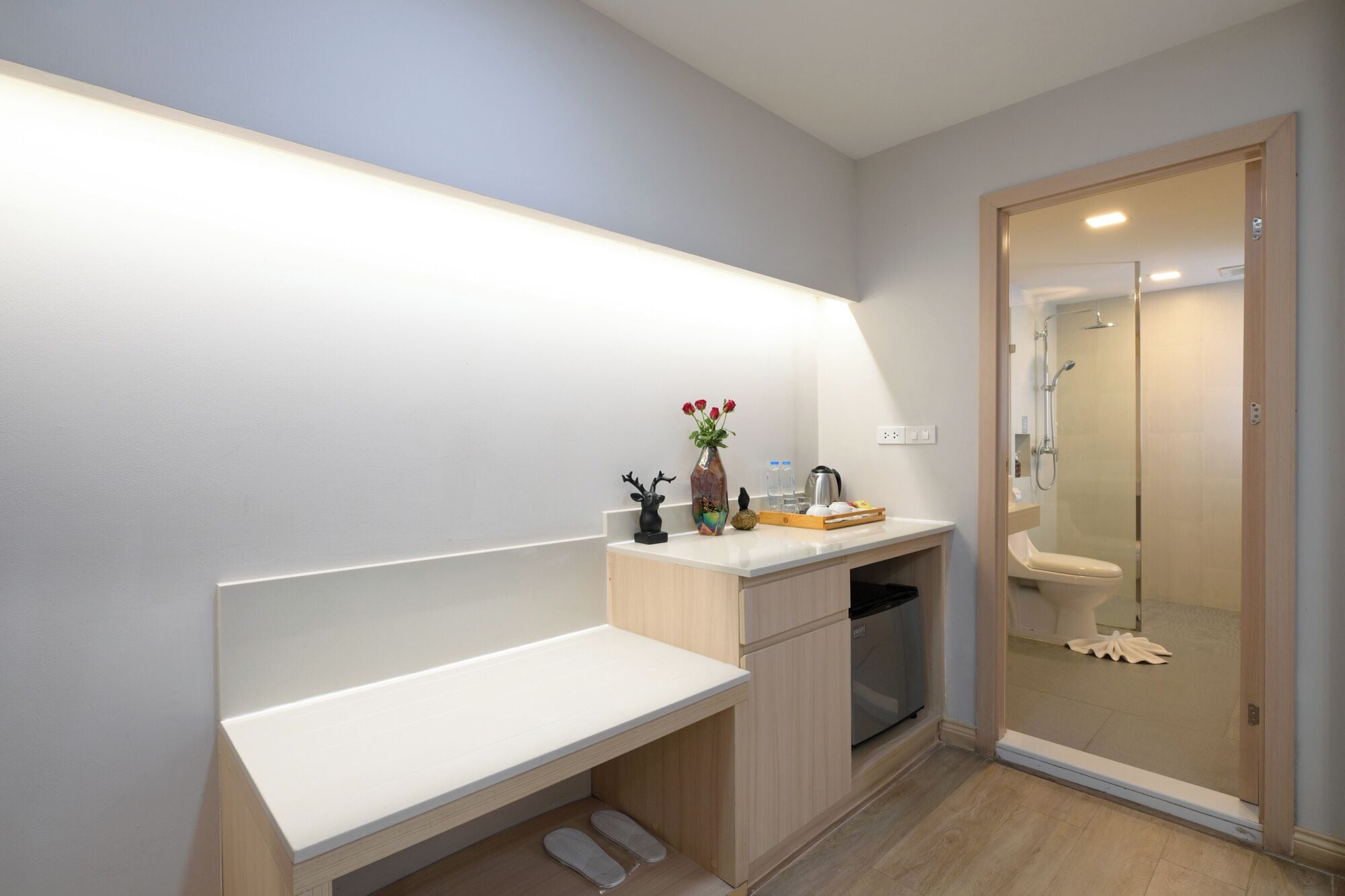 A modern bathroom with a shower, toilet, and a vanity with a sink and countertop.