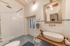 Shower, hair dryer, towels, toilet paper