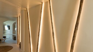 A modern interior with wooden beams and soft lighting. - Divelia East (Santorini)