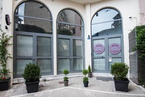 A building with large arched windows and a sign that reads "BED ATHENS". - BED in Athens (Athens)