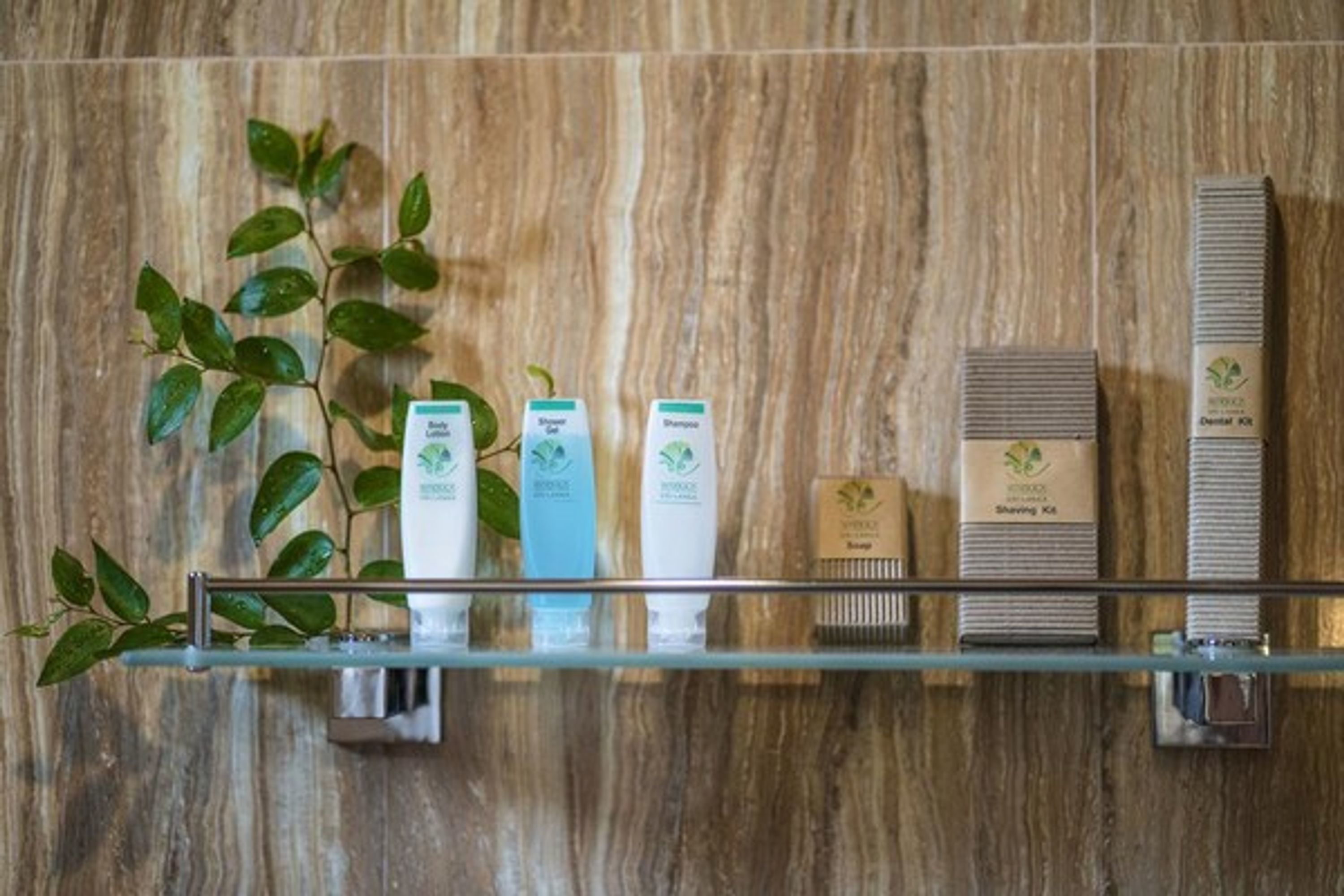 A bathroom shelf with various toiletries including a toothbrush, toothpaste, and a razor.