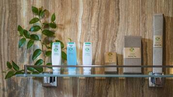 A bathroom shelf with various toiletries including a toothbrush, toothpaste, and a razor.