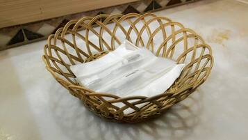 A wicker basket on a tiled floor.