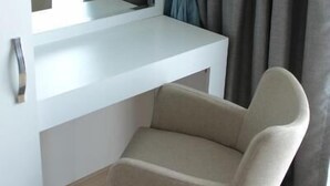 A room with a white desk, a chair, and a window with curtains. - Parion House Hotel (Çanakkale)