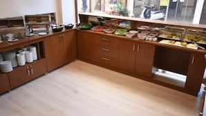 A buffet setup with various food items and utensils. - Parion House Hotel (Çanakkale)