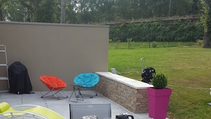 An outdoor dining area with a table set for breakfast, including bread, cheese, and beverages. - La Vertabelle (Vertou)