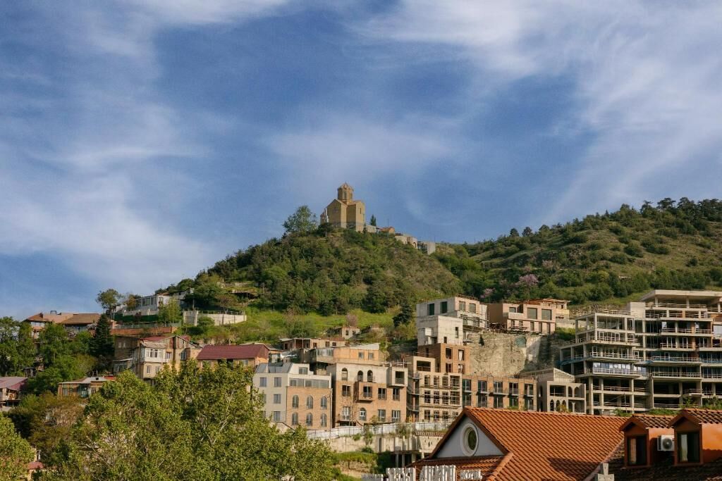 A hillside town with buildings, including a prominent church on a hill.