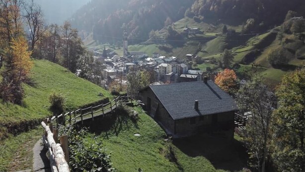 A rural village with stone buildings, a wooden bridge, and surrounding hills. - Hotel Ristorante Valle Del Bitto (Gerola Alta)