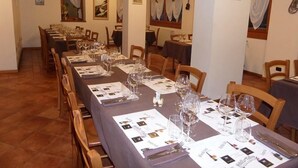A dining area with multiple tables set for a meal, featuring menus and wine glasses. - Hotel Ristorante Valle Del Bitto (Gerola Alta)
