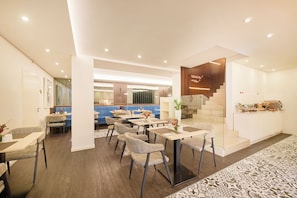 Enjoy meals in a spacious dining area with tables and chairs.