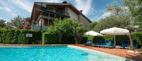 Seasonal outdoor pool, pool umbrellas, pool loungers