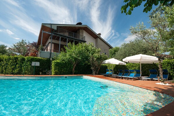 Seasonal outdoor pool, pool umbrellas, pool loungers