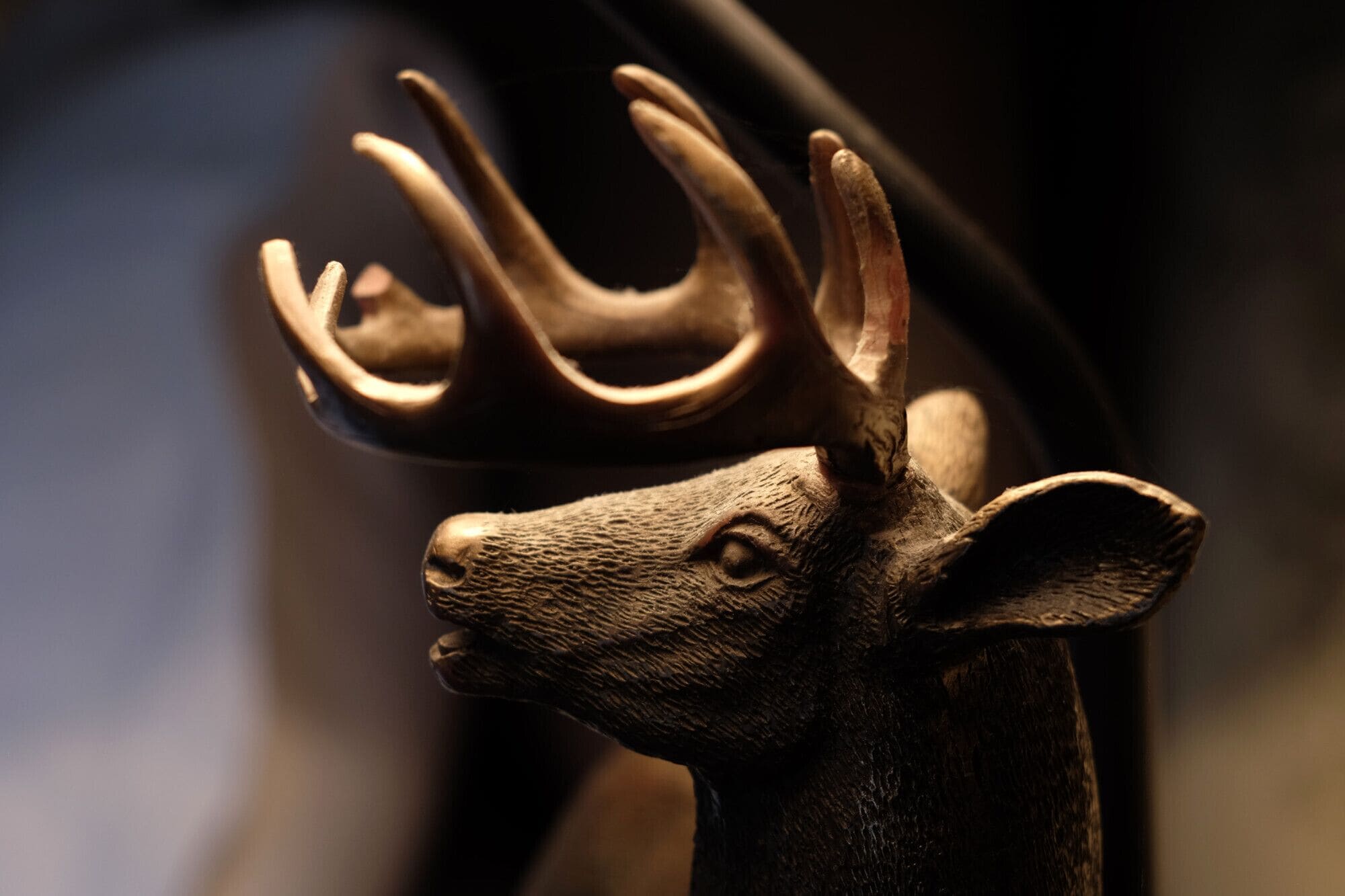 A close-up of a deer head sculpture with antlers.