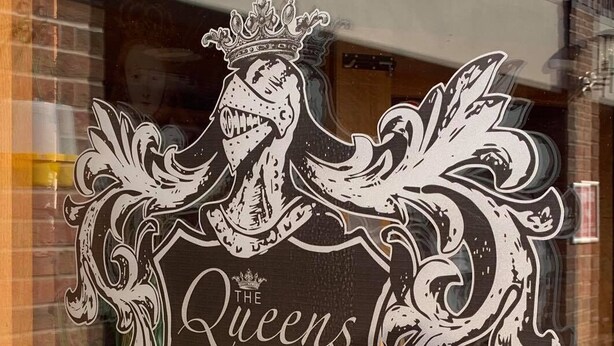 A window decal of "The Queens at Horton" with a crest and shield design. - The Queens at Horton (Telford)