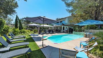 Seasonal outdoor pool, open 9:00 AM to 9:30 PM, pool umbrellas