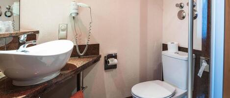 A bathroom with a sink, toilet, and shower.