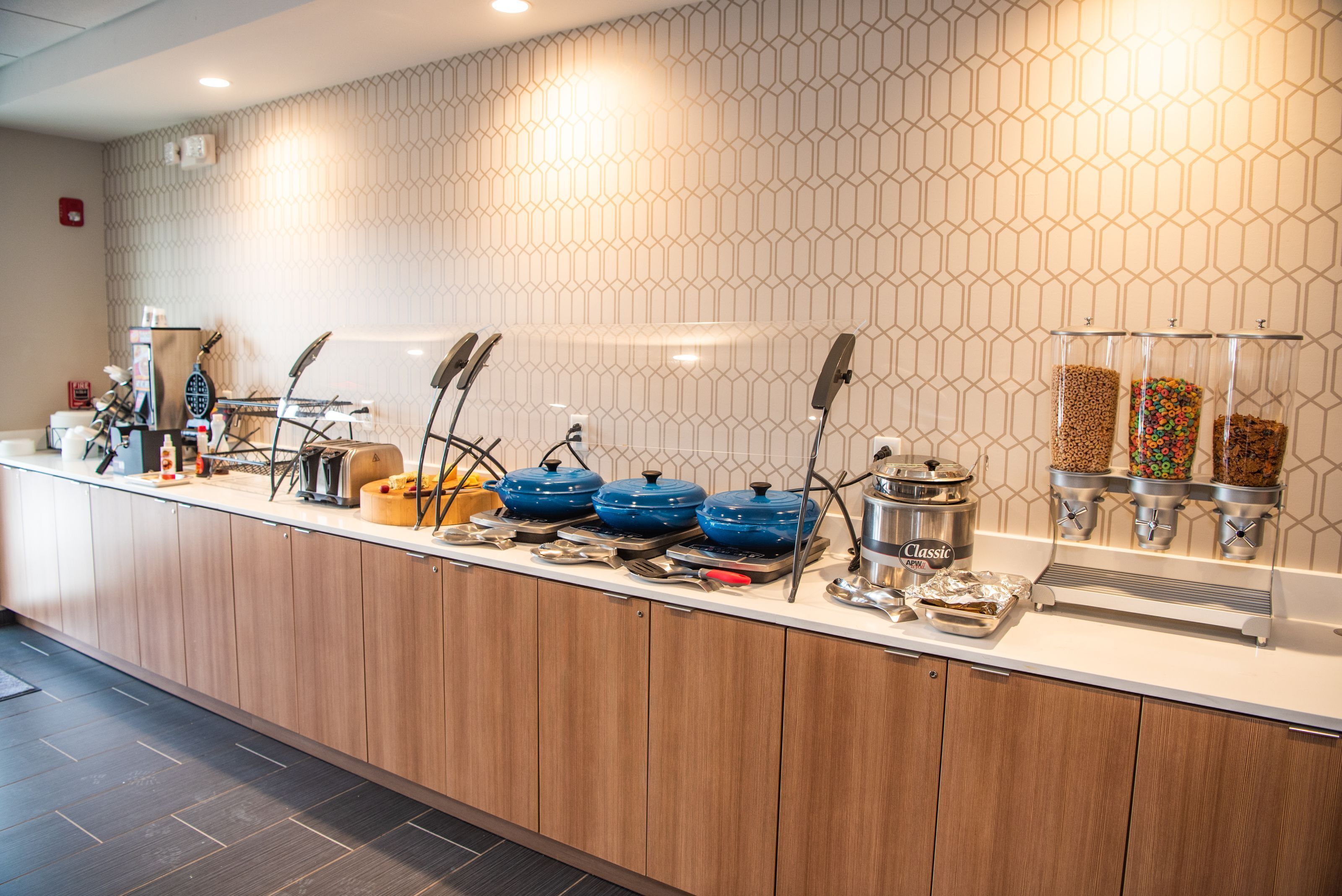 A breakfast bar with various food dispensers, including cereal and granola.