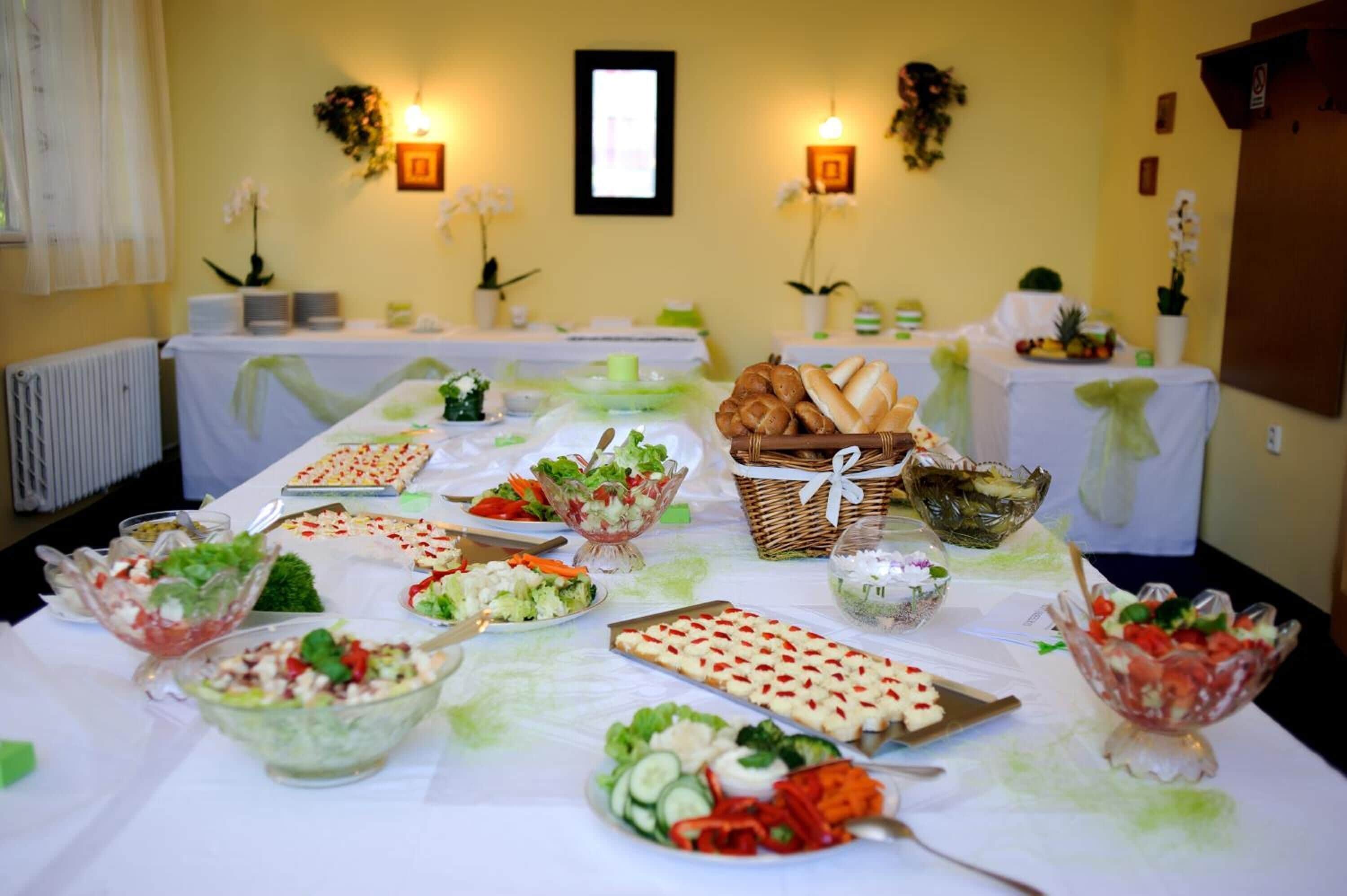 A buffet table with various food items and decorations.