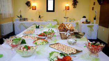 A buffet table with various food items and decorations.