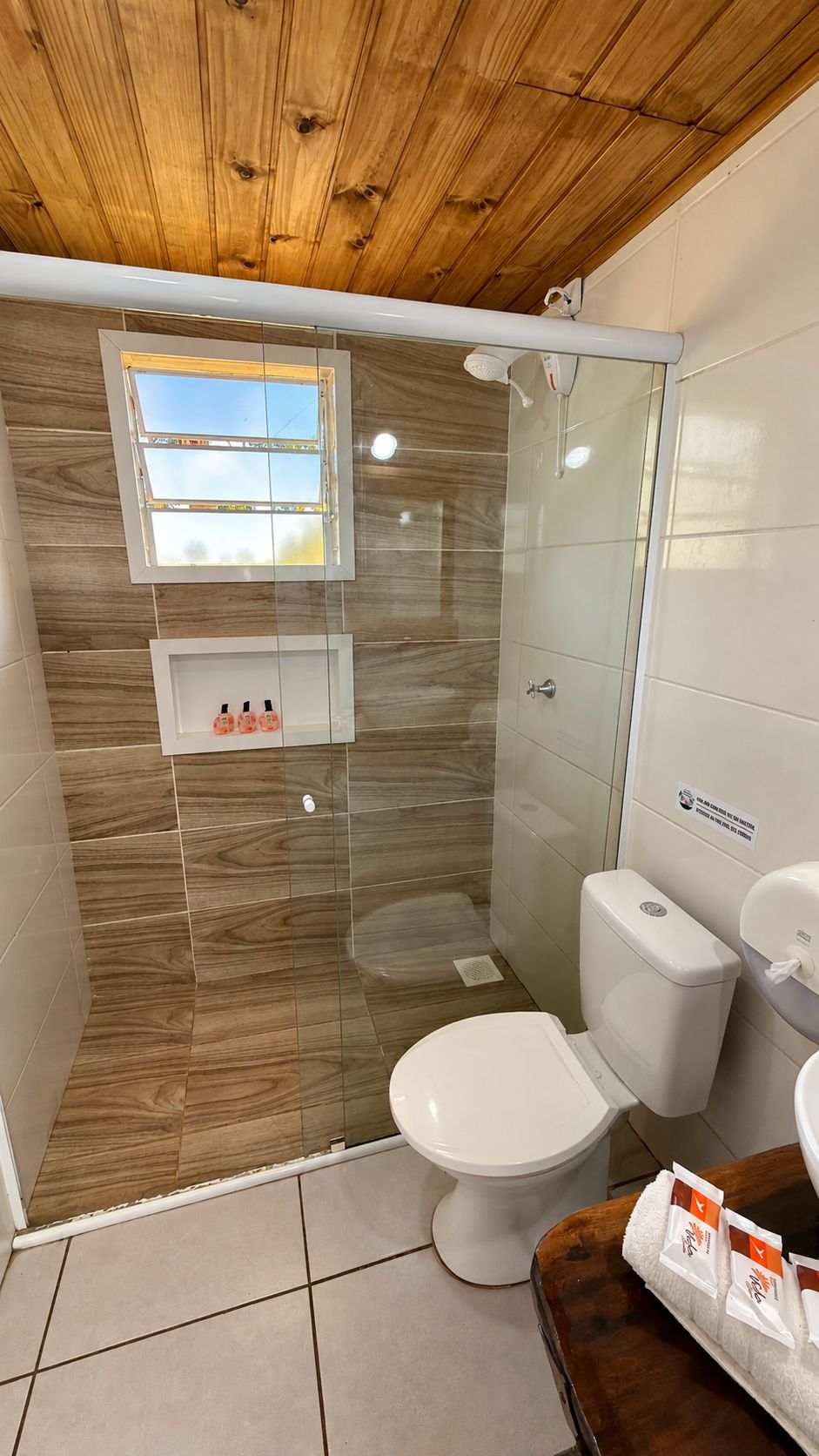 A bathroom with a shower, toilet, and sink.